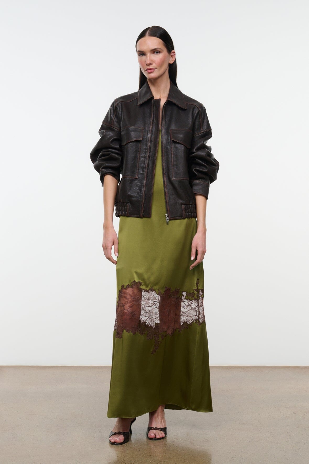 Olive green silk dress with spaghetti straps and brown-and-white lace hem, styled with jacket