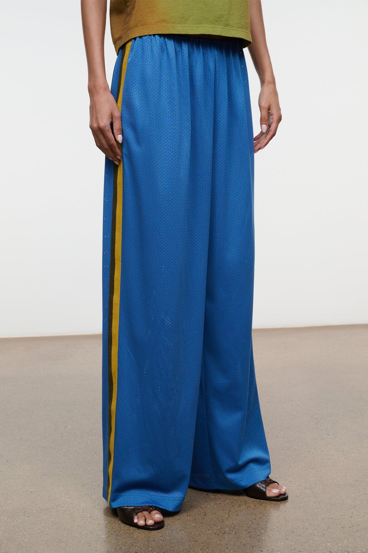 Blue wide-leg pants with elastic waist and yellow side stripe, full length