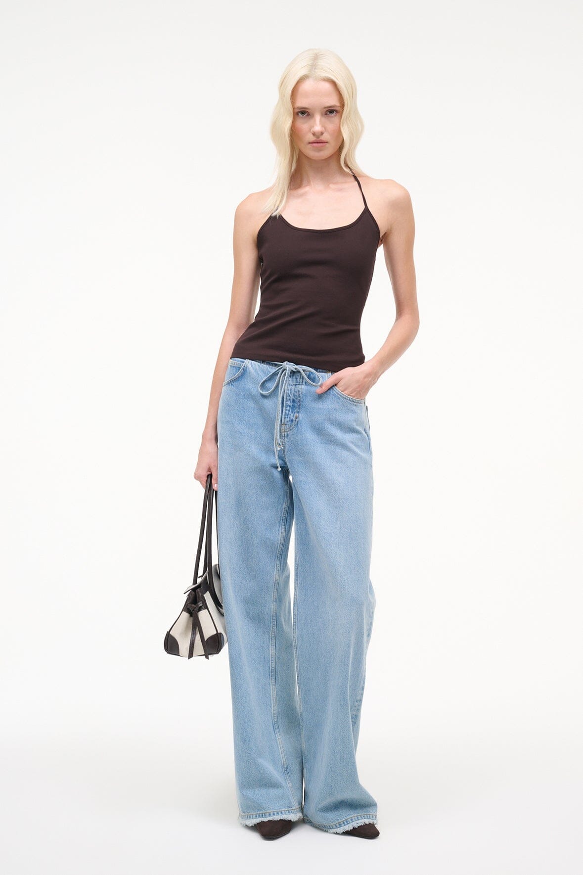 Dark brown halter tank top with thin straps, paired with blue drawstring jeans