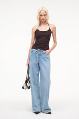 Dark brown halter tank top with thin straps, paired with blue drawstring jeans