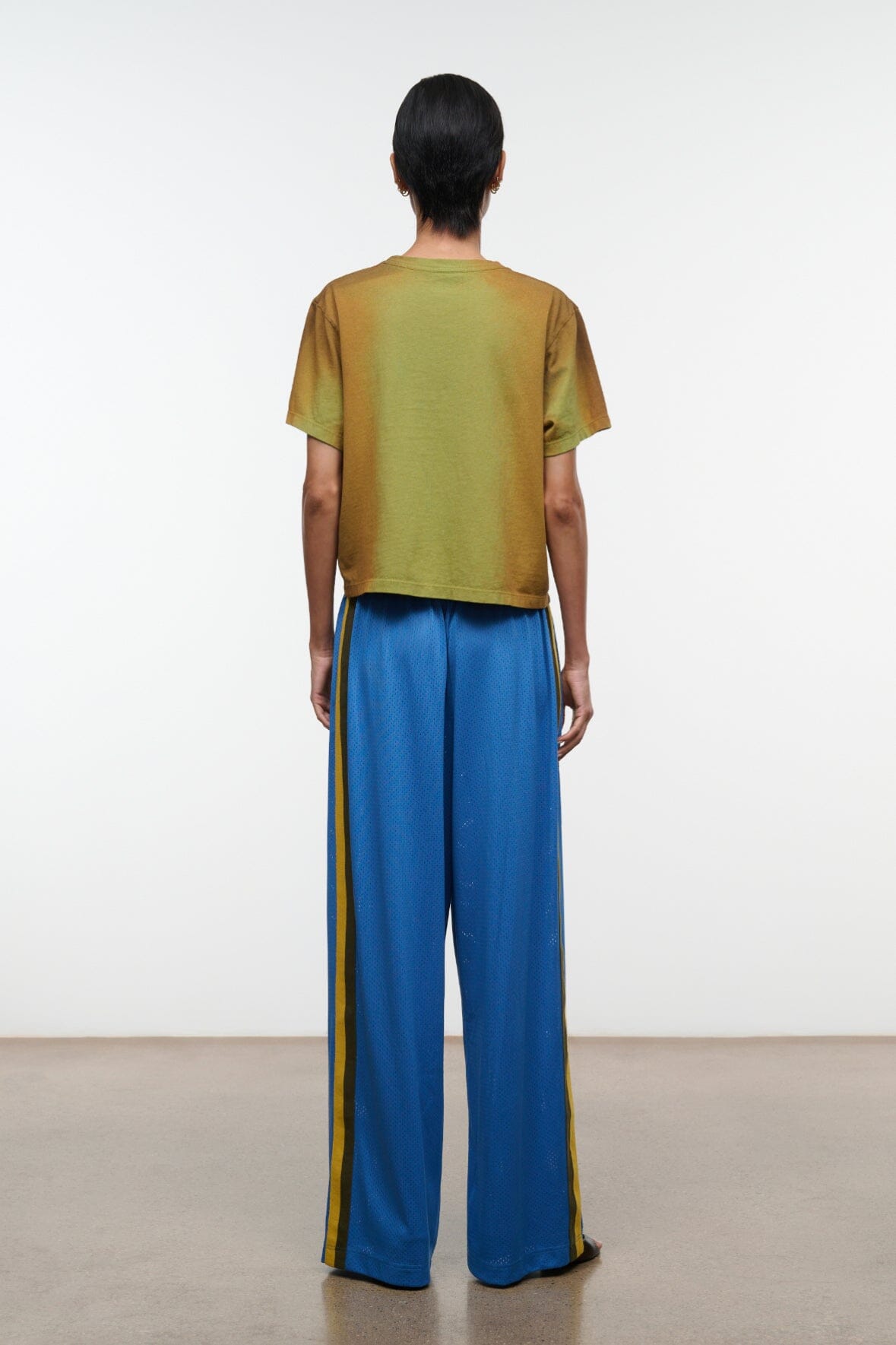 Blue wide-leg pants with yellow side stripe and elastic back waistband