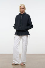 Black hooded wind jacket with elastic waist and drawstring hem, long sleeves