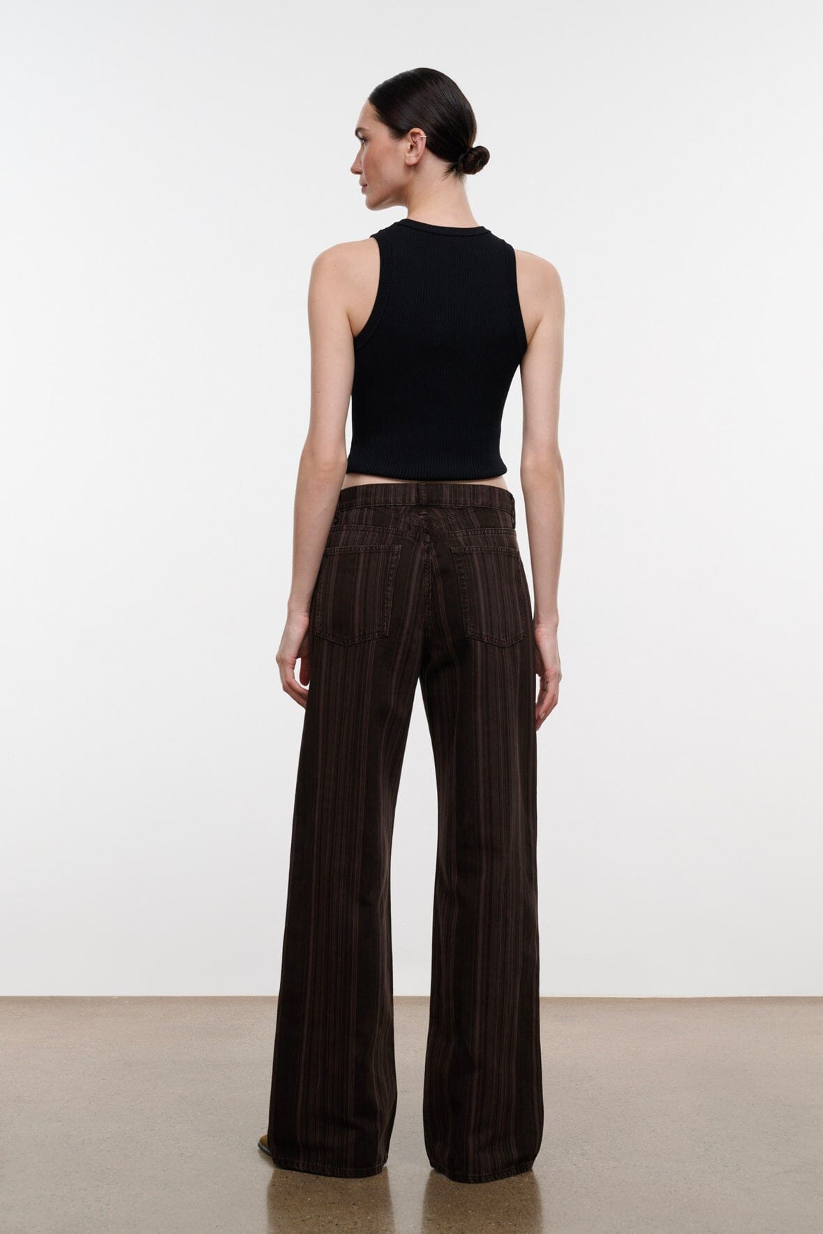 Dark brown espresso-striped relaxed jeans viewed from behind, wide leg