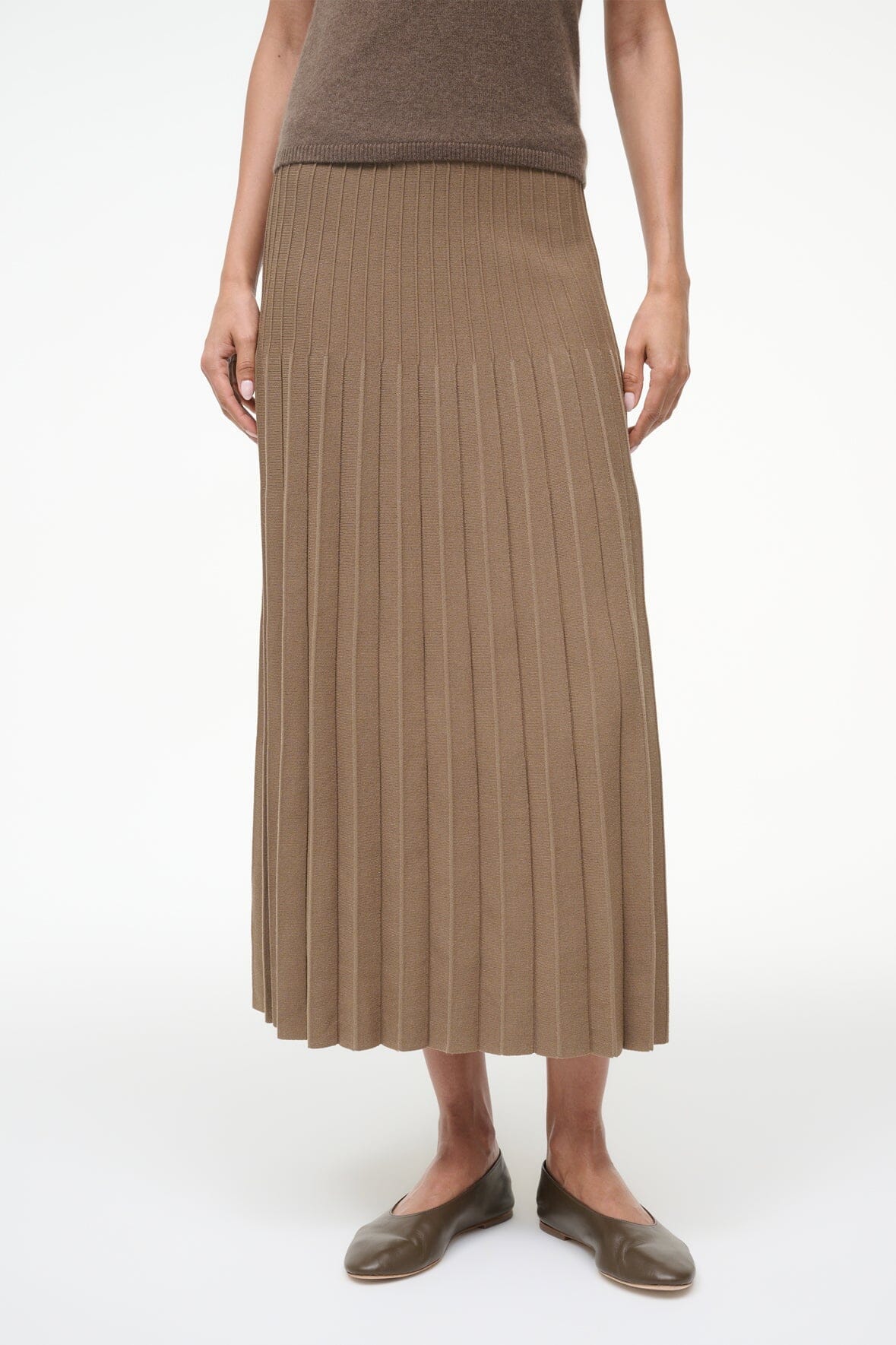 Brown ribbed knit midi skirt with pleated vertical texture and elastic waistband