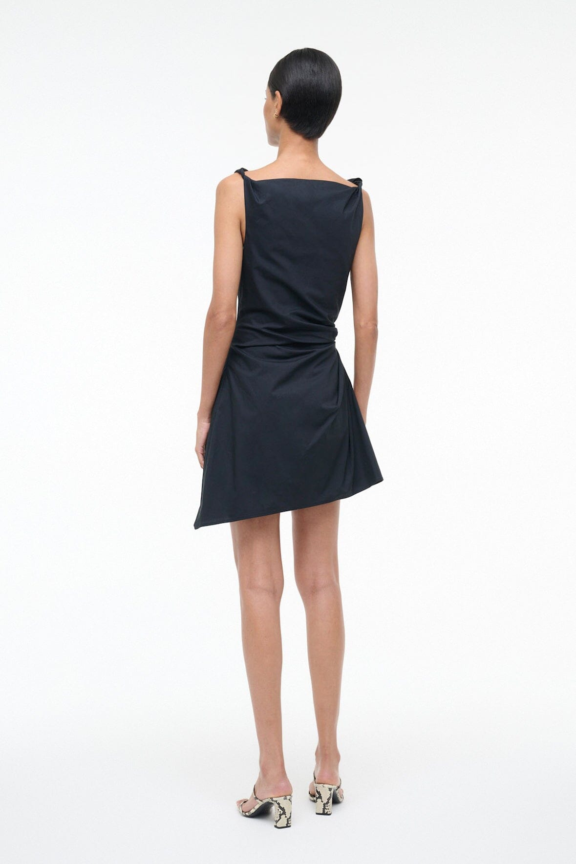 Black sleeveless mini dress with draped bodice and fitted waist, back view