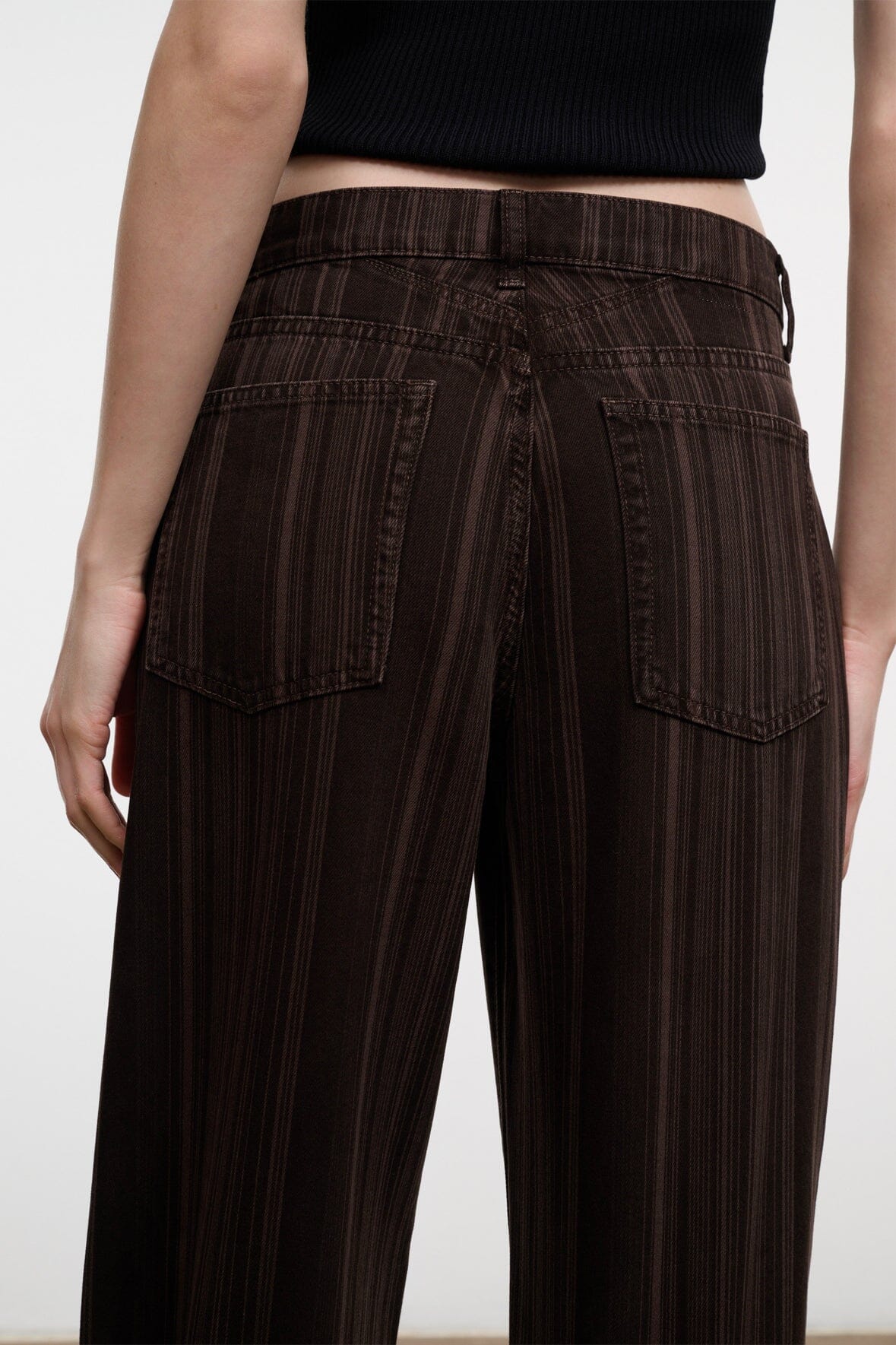 Dark brown espresso-striped relaxed jeans close-up of back pockets and belt loops