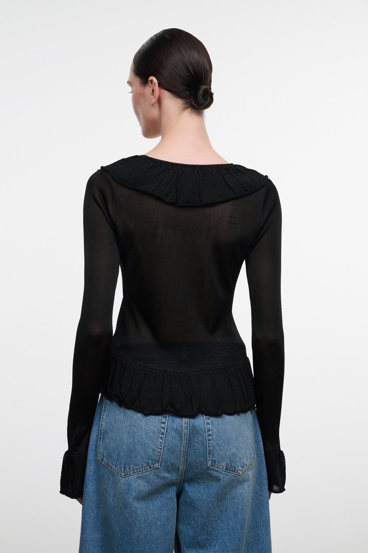 Black long-sleeve top with ruffled back yoke and gathered hem