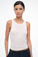 Ivory ribbed tank top on model, scoop neck with small front embroidery