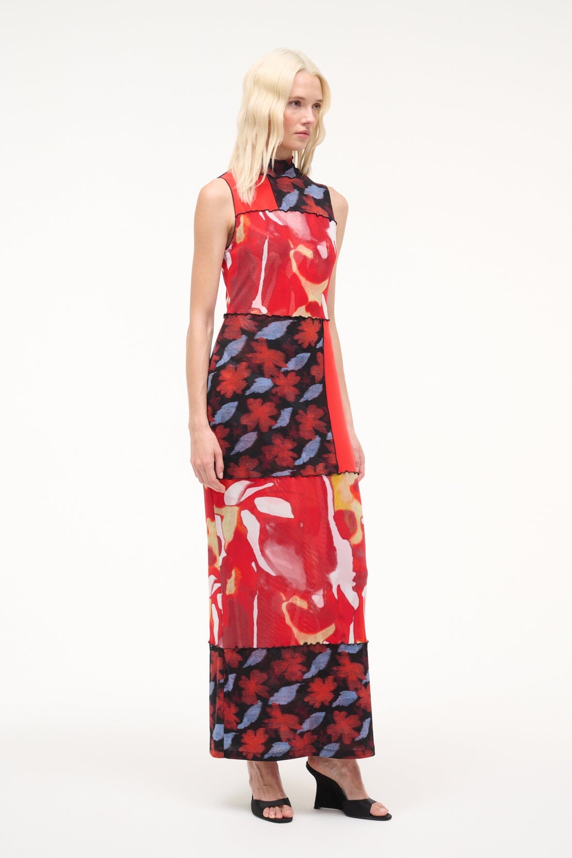 Black high-wedge slide sandals worn with a sleeveless red and floral maxi dress