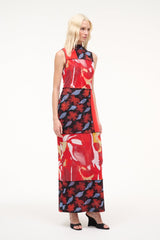 Black high-wedge slide sandals worn with a sleeveless red and floral maxi dress