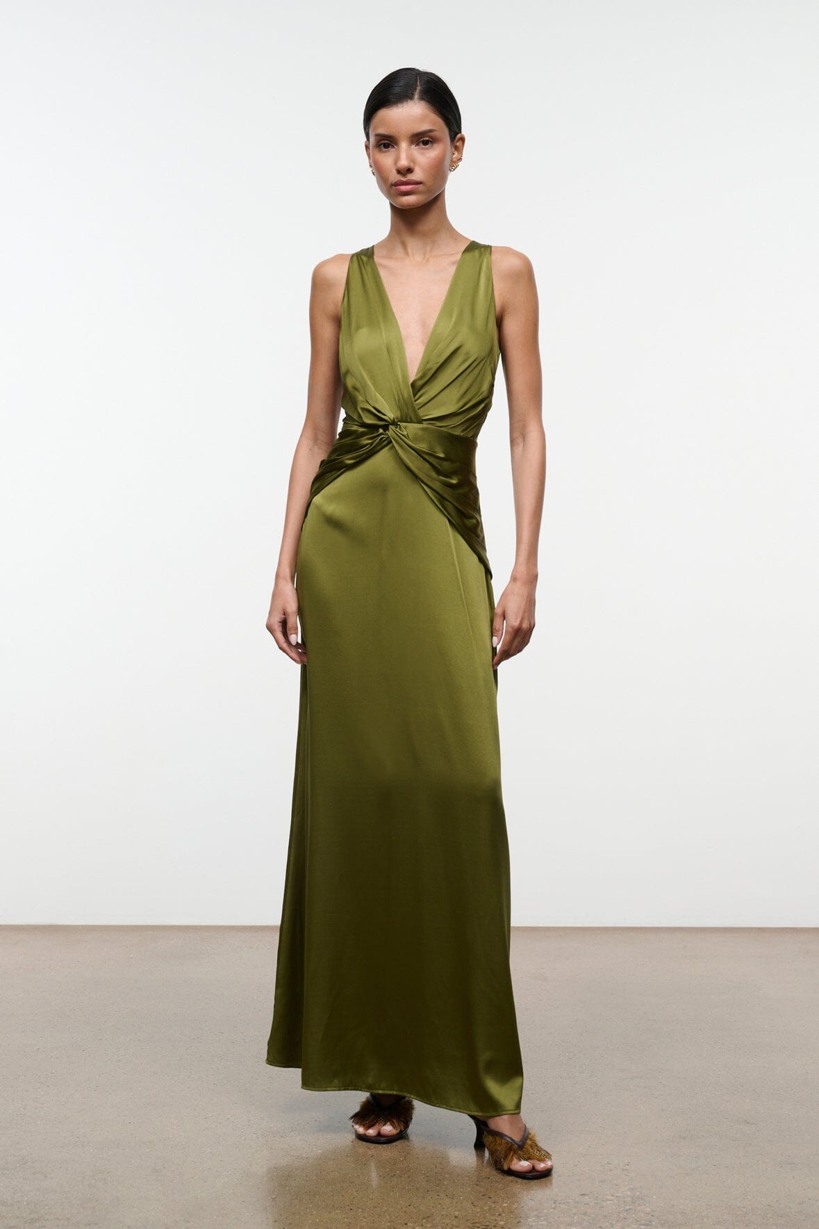 Olive green silk maxi dress with deep V-neck and twisted knot at waist, side view