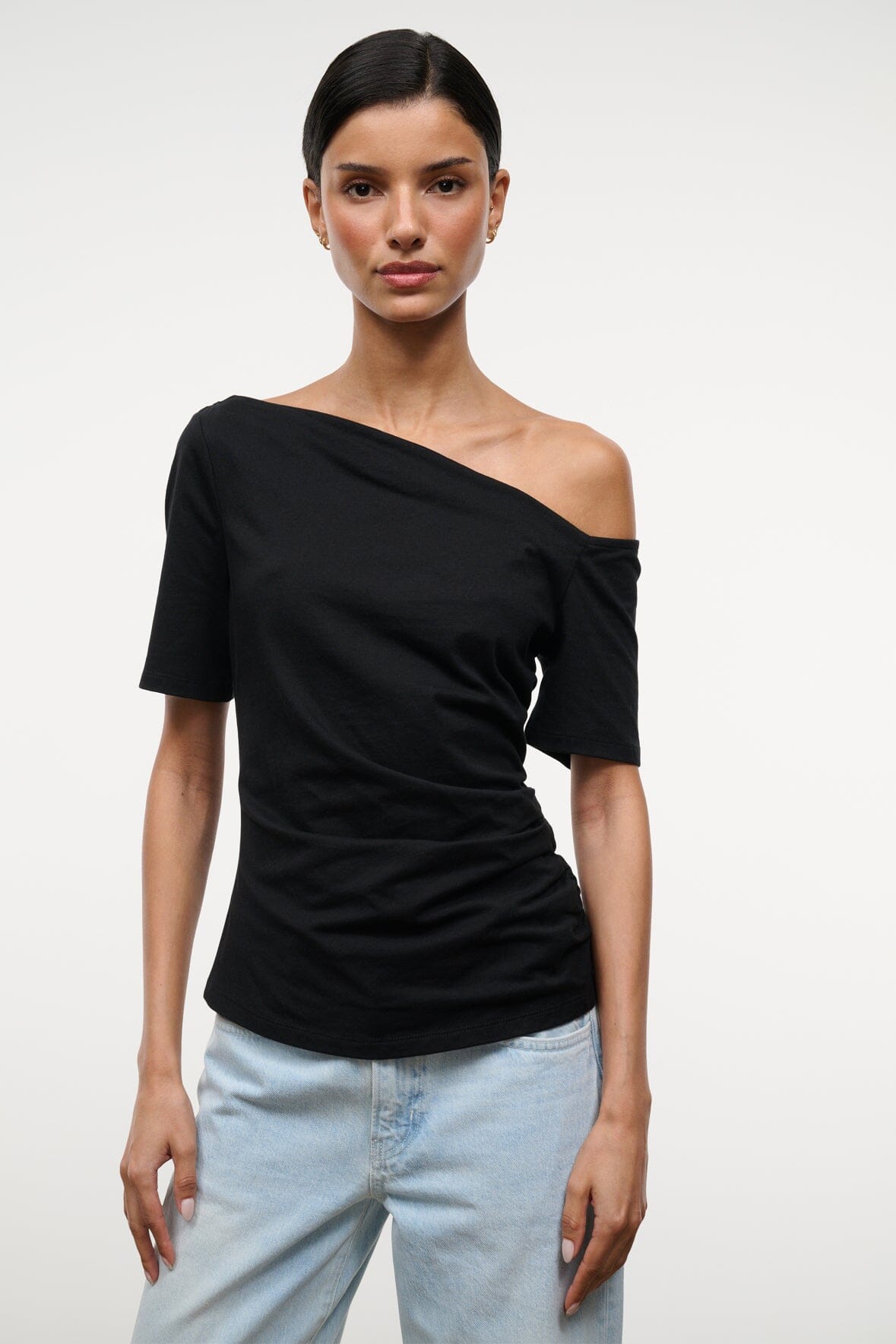 Black Carine top with diagonal off-shoulder neckline, short sleeves, fitted drape front