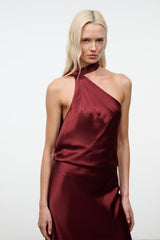 Wine satin halter dress with draped one-shoulder neckline, sleeveless, bias silhouette.