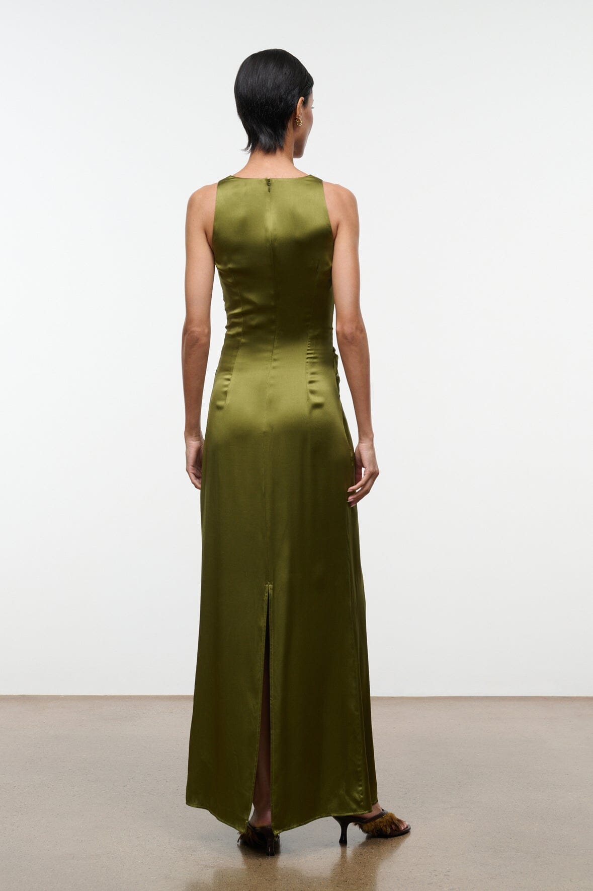 Olive green silk maxi dress back view, sleeveless with center seam and back slit