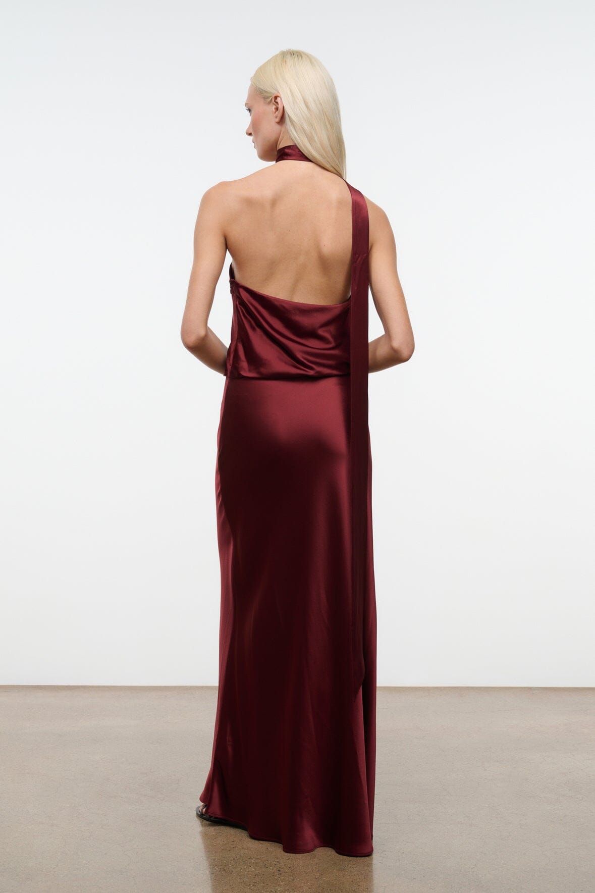 Wine satin halter maxi dress with open back and center seam, low scoop back.