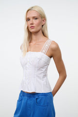 White sleeveless fitted top with lace-trim straps and front buttons