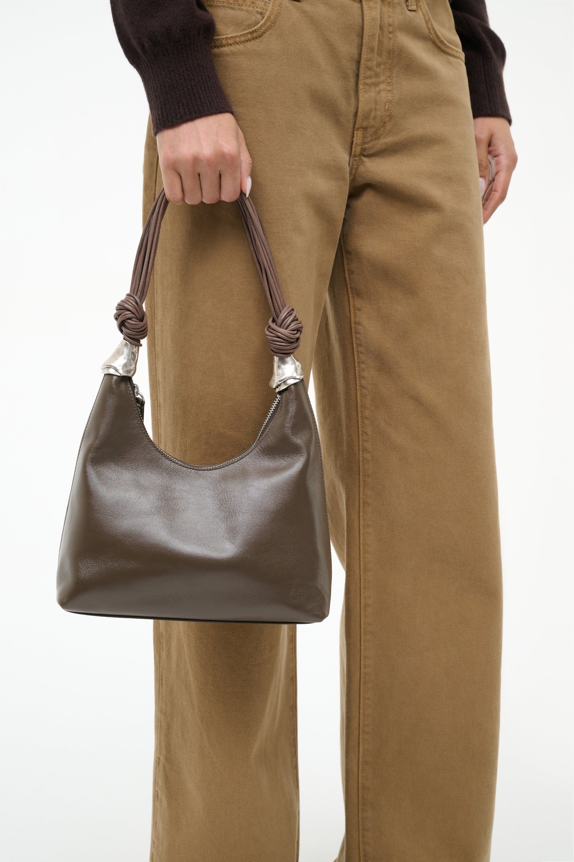 Truffle brown shoulder bag with braided cuff handles and silver knot detail