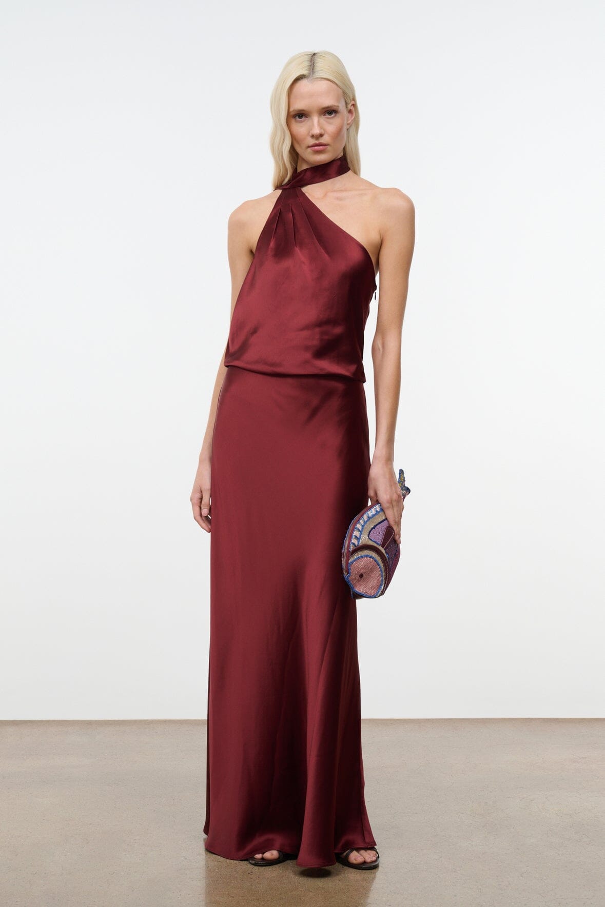 Wine satin halter maxi dress with V halter neckline and smooth draped skirt.