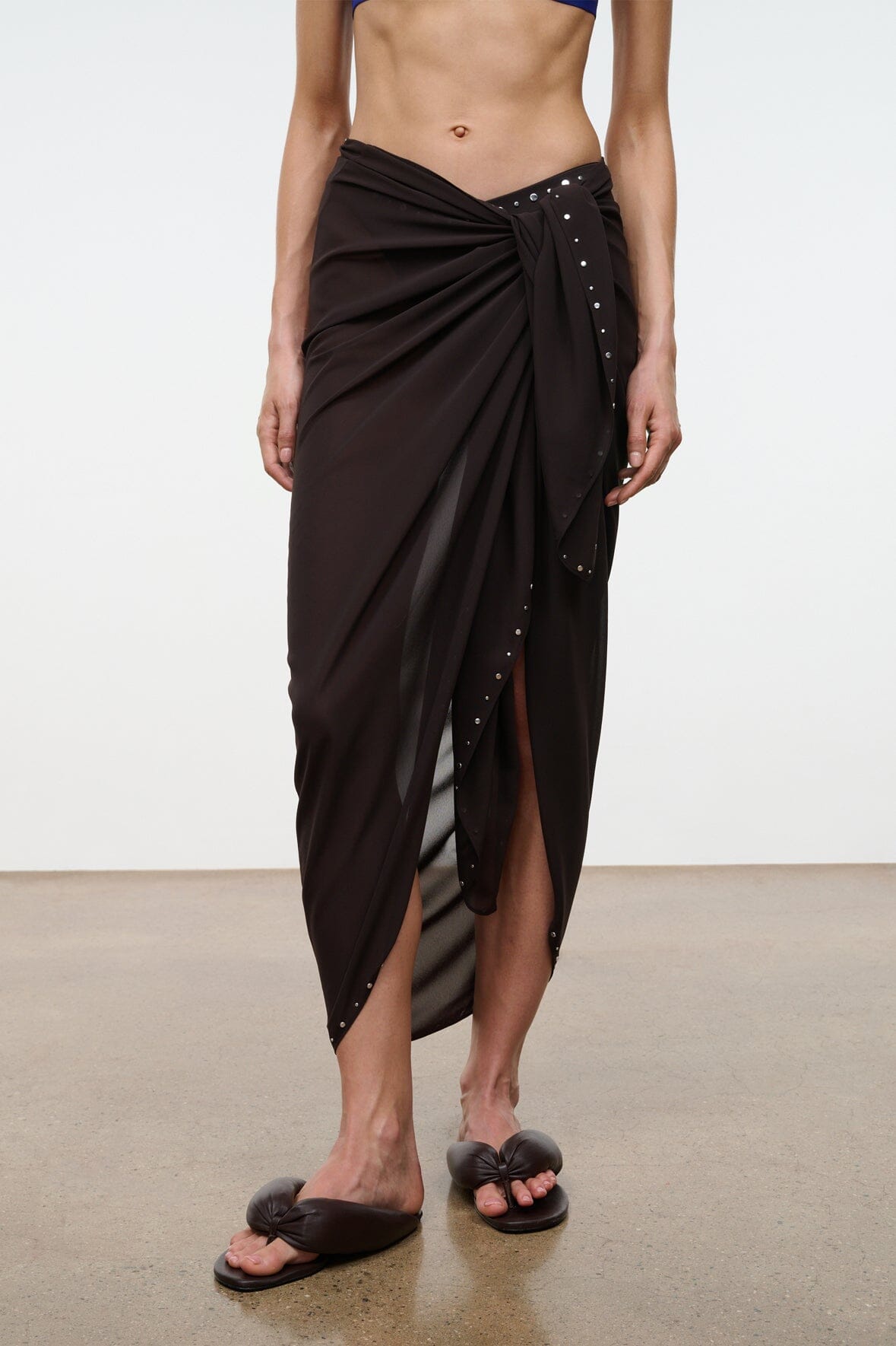 Brown stud-trim sarong wrap skirt with draped front and side slit