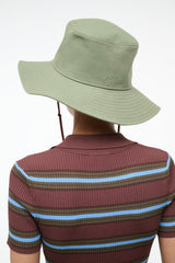 COAST bucket hat in fern green with wide brim and side logo, with chin cords