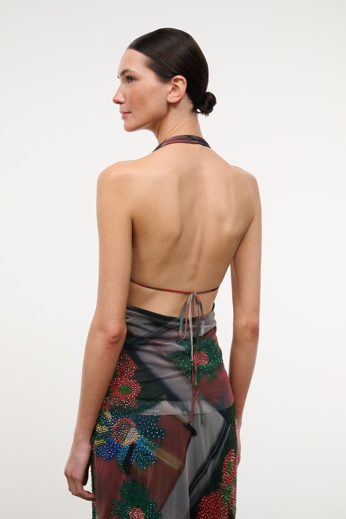 Backless sleeveless beaded top with tie straps, dark floral pattern and sheer panels