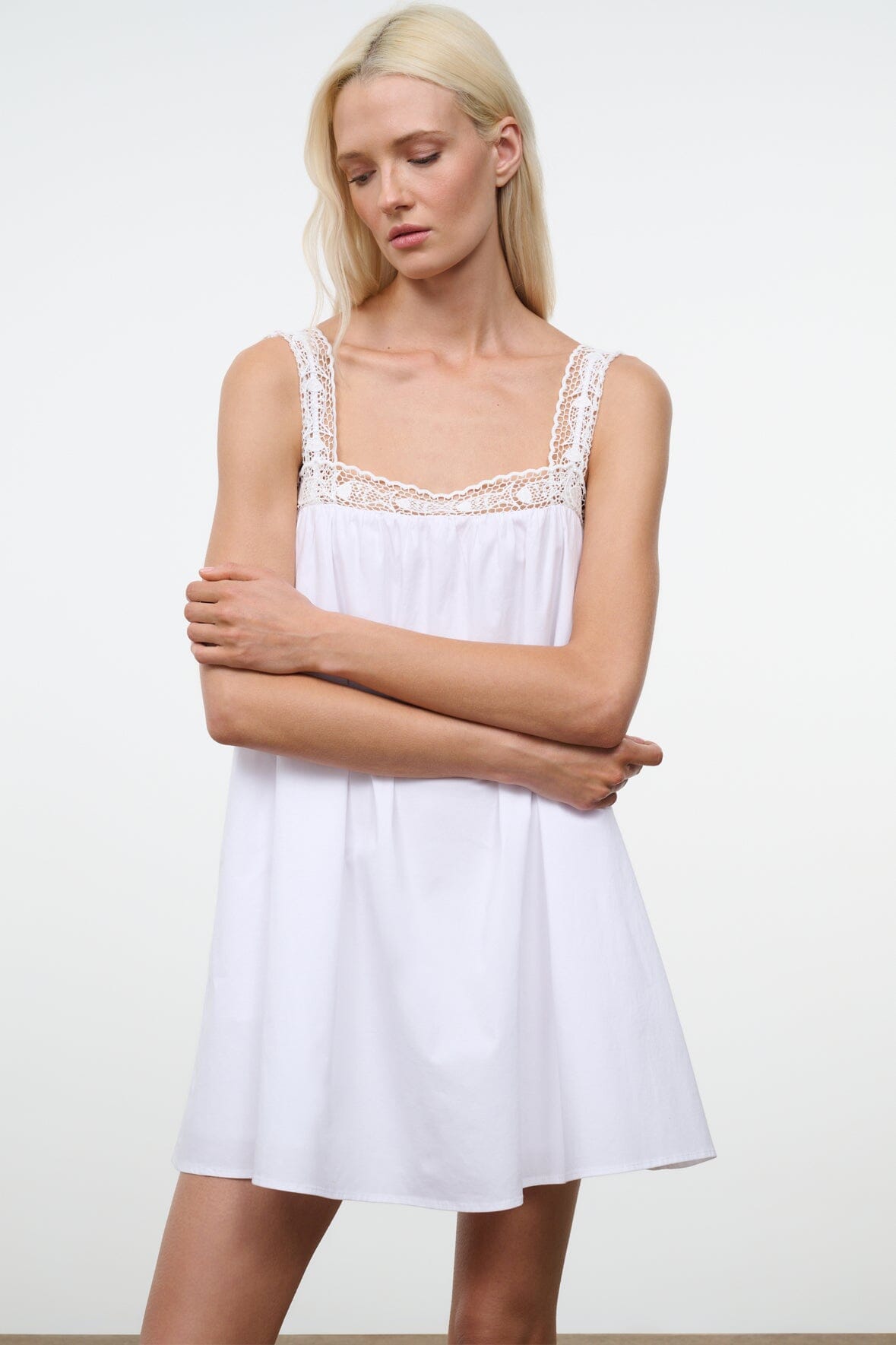 White sleeveless dress with lace-trim neckline and loose A-line skirt