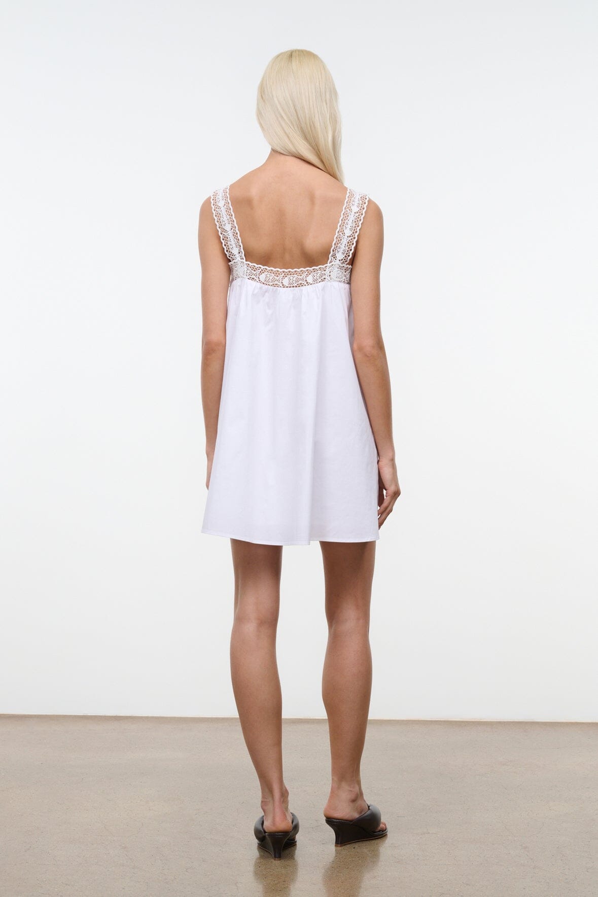 White dress with lace back yoke and open-back design