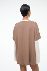 Taupe short-sleeve tee with lace-trim hem and white long-sleeve underlayer, back view