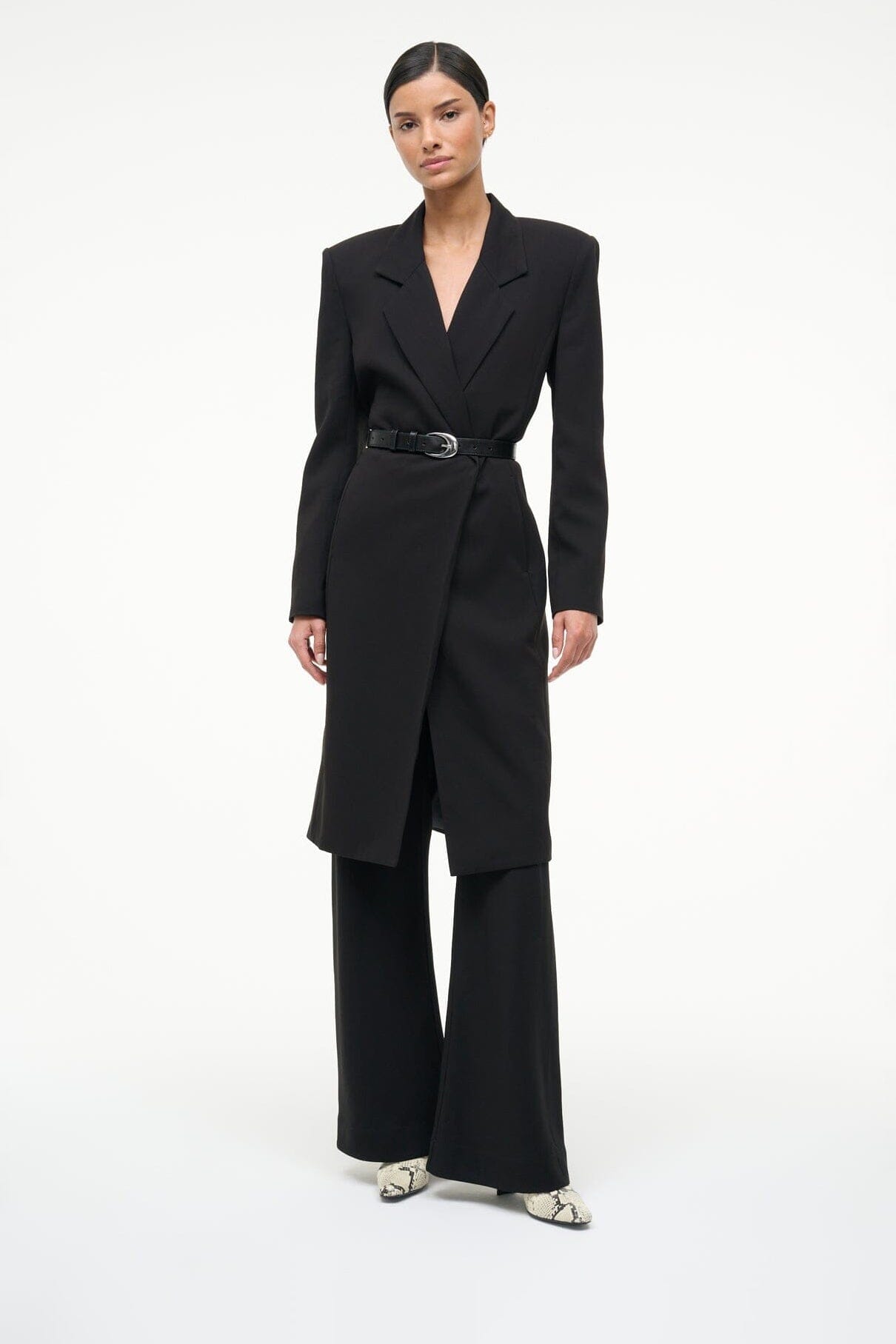 White snake-print ankle boots worn with a black wide-leg suit pant