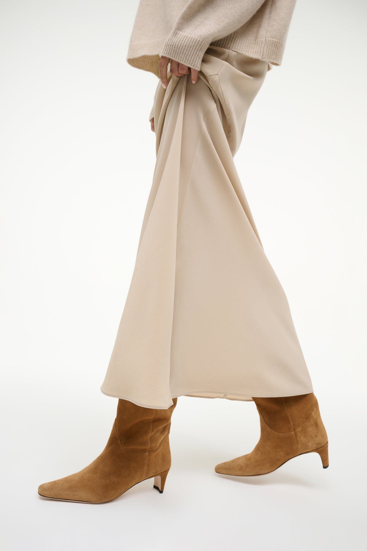 Tan suede western ankle boots with pointed toe and mid-height heel