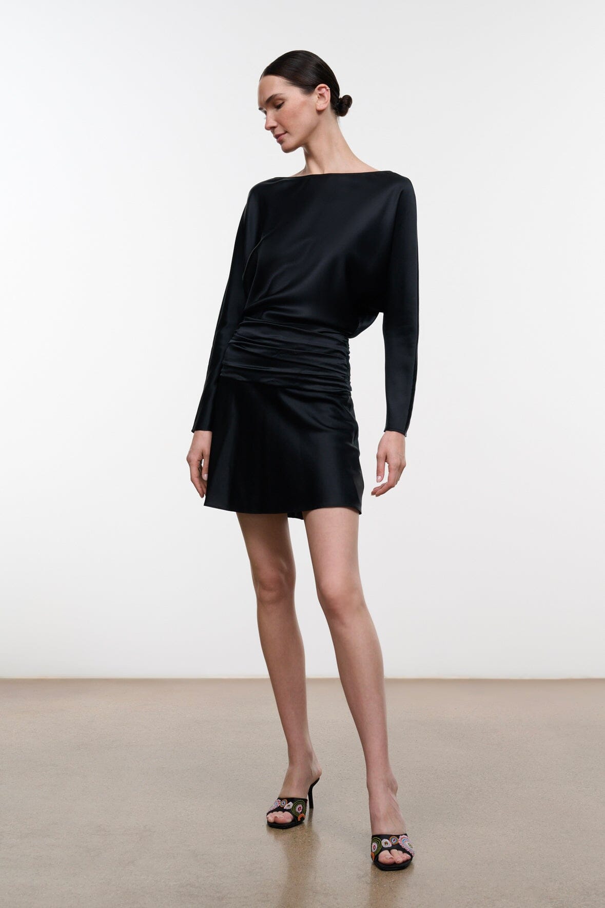 Black silk mini dress with ruched front waist and long sleeves