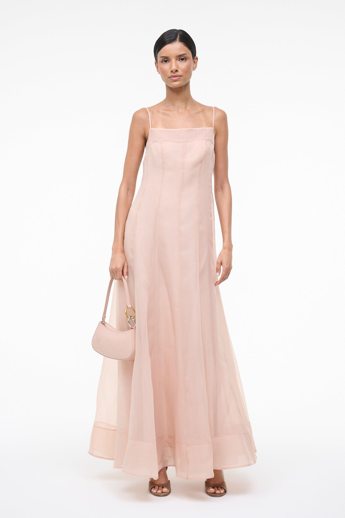 Fawn sleeveless tiered maxi dress with square neckline, holding a small clutch