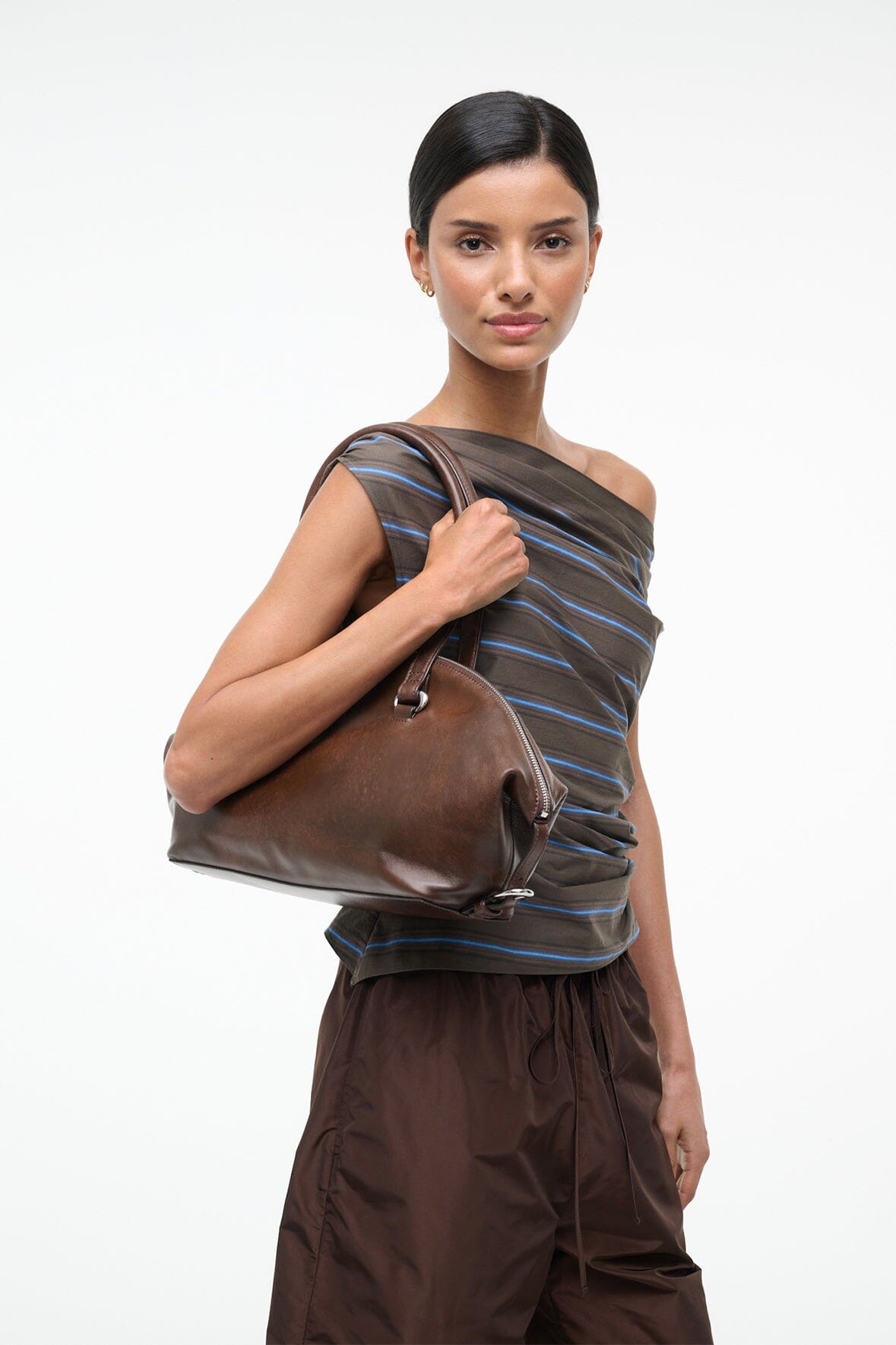 Distressed brown shoulder bag with top zipper and dual short handles