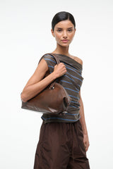 Distressed brown shoulder bag with top zipper and dual short handles