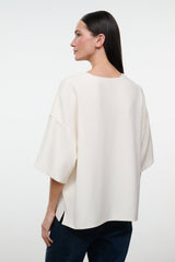 Ivory boxy short-sleeve tee, loose drape, back view