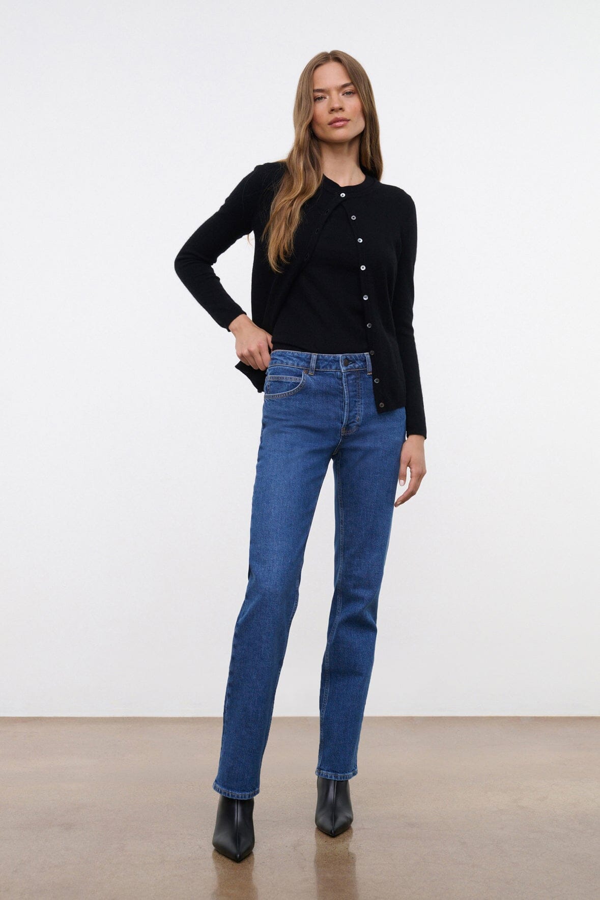 Stone blue straight stretch jeans on model, front view with belt loops