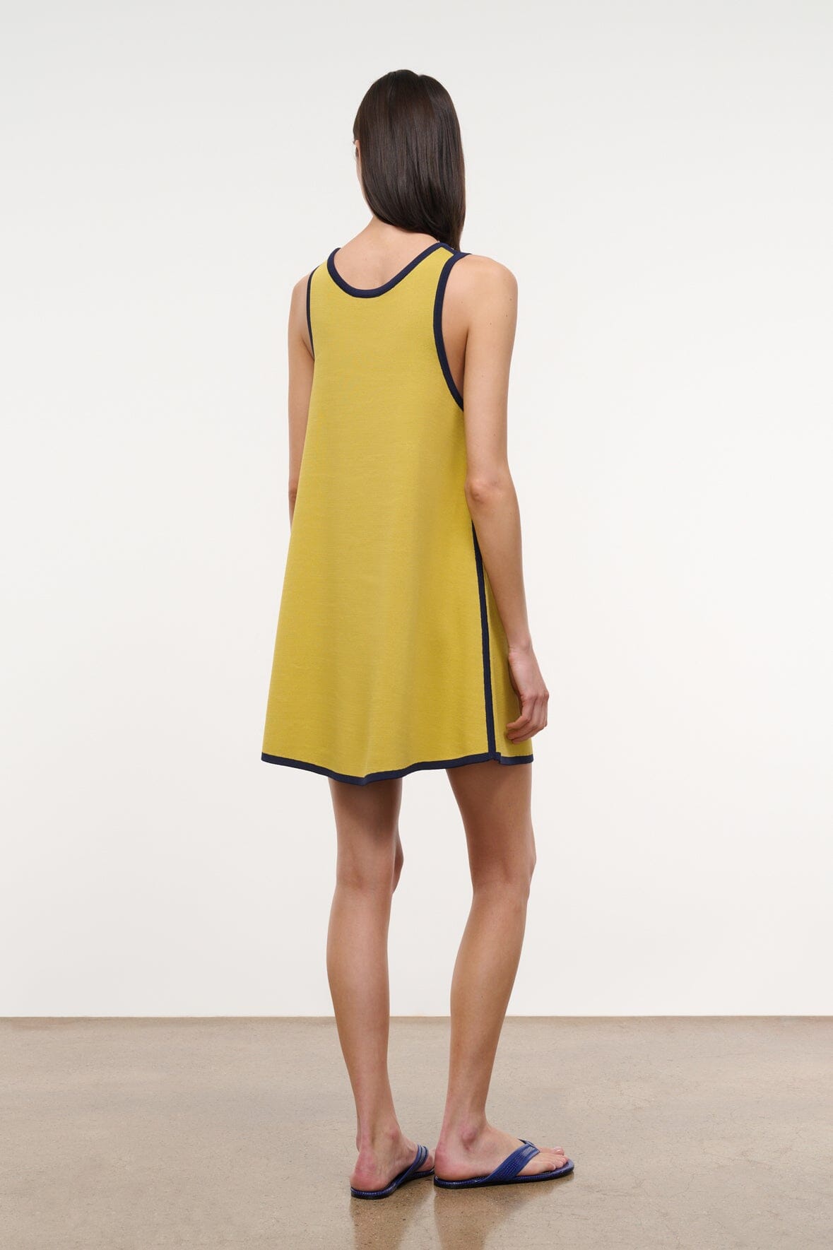 Sleeveless yellow shift dress with navy trim around neckline and hem edge