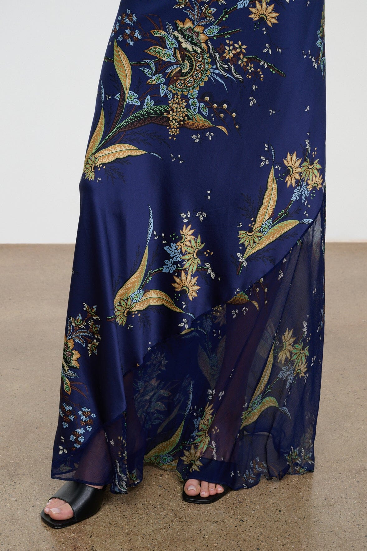 Silk halter dress in dark blue with gold botanical tapestry print, draped skirt