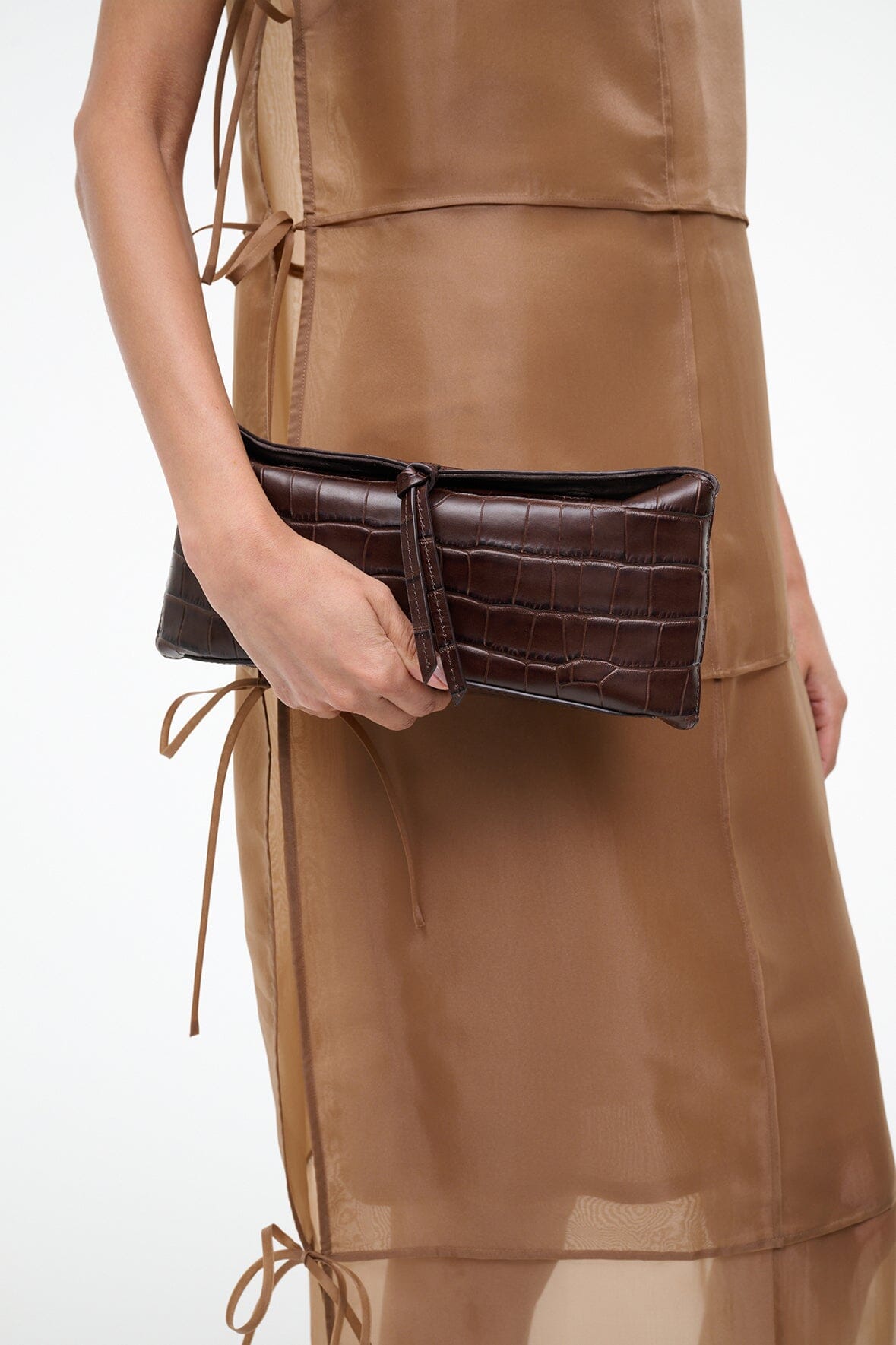 Dark brown croc-textured leather clutch with top clasp, side view