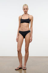 Black halter bikini top with colorful beaded straps, styled with matching bottoms
