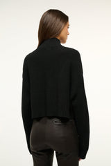 Black cropped cashmere sweater, back view with ribbed knit cuffs