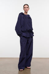 FLO pants in dark navy with loose wide-leg fit and elastic waist, front view