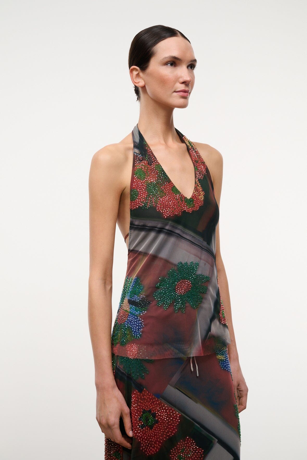 Sleeveless beaded V-neck top with floral motifs, dark sheer design and multicolor accents