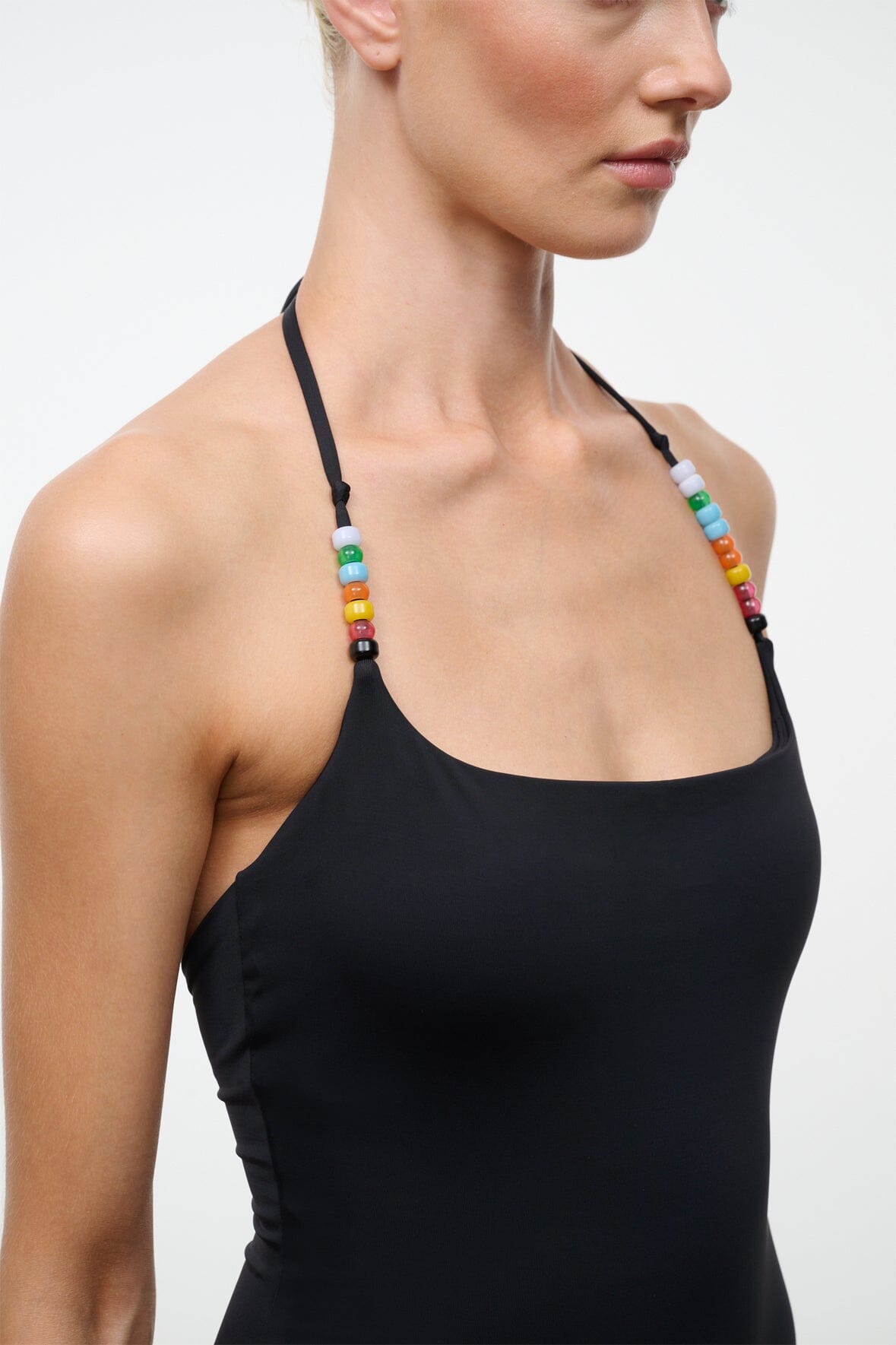 Black one-piece swimsuit close-up: multicolor beaded thin straps