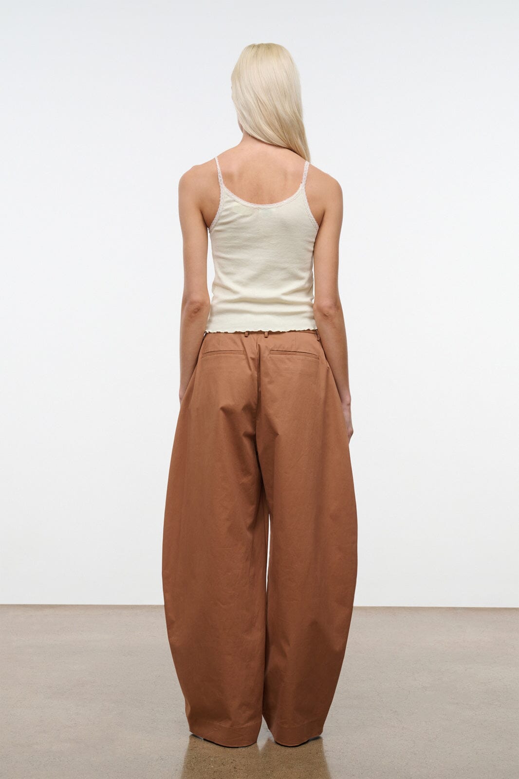 Carob brown high-rise wide-leg pants, back view with center seam