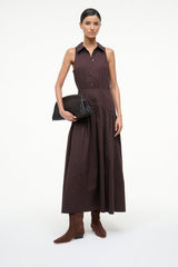 Wally flat suede boots in mahogany brown, worn with a sleeveless dress; side view.