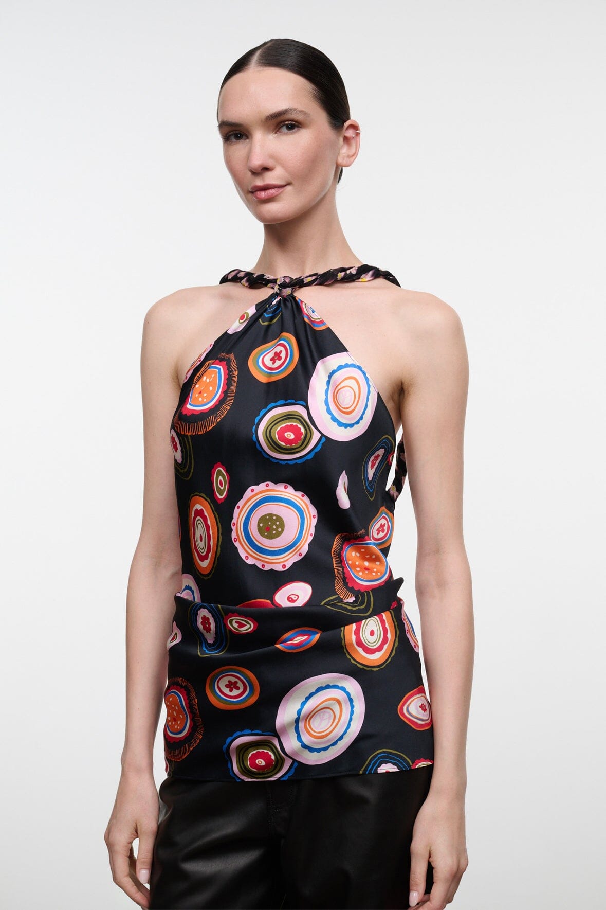Silk halter top with multicolor circular print on black, sleeveless keyhole