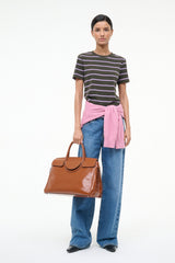 Brown leather-look carryall handbag with top handles and front pocket flaps
