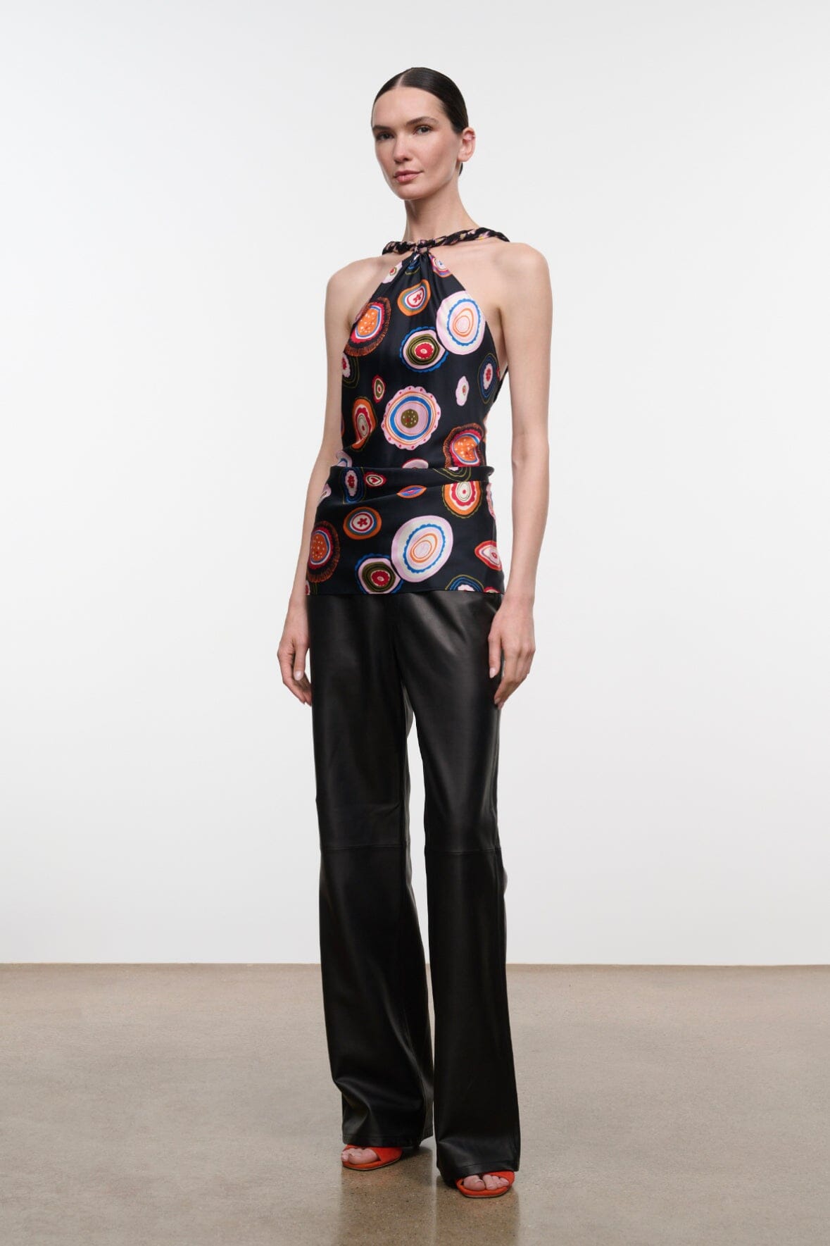 Silk halter top with black base and multicolor circular print, gathered waist