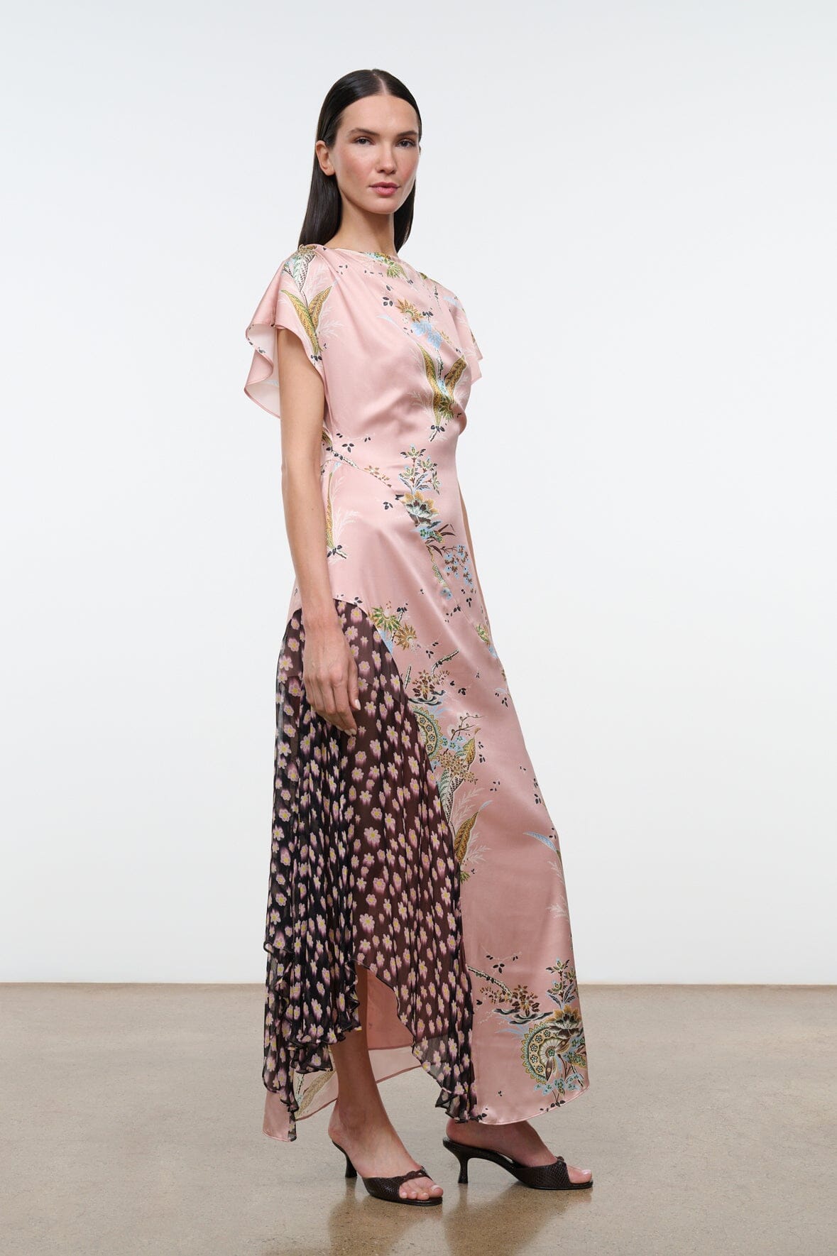 Pink floral maxi dress with flutter sleeves and sheer black side panel detail.